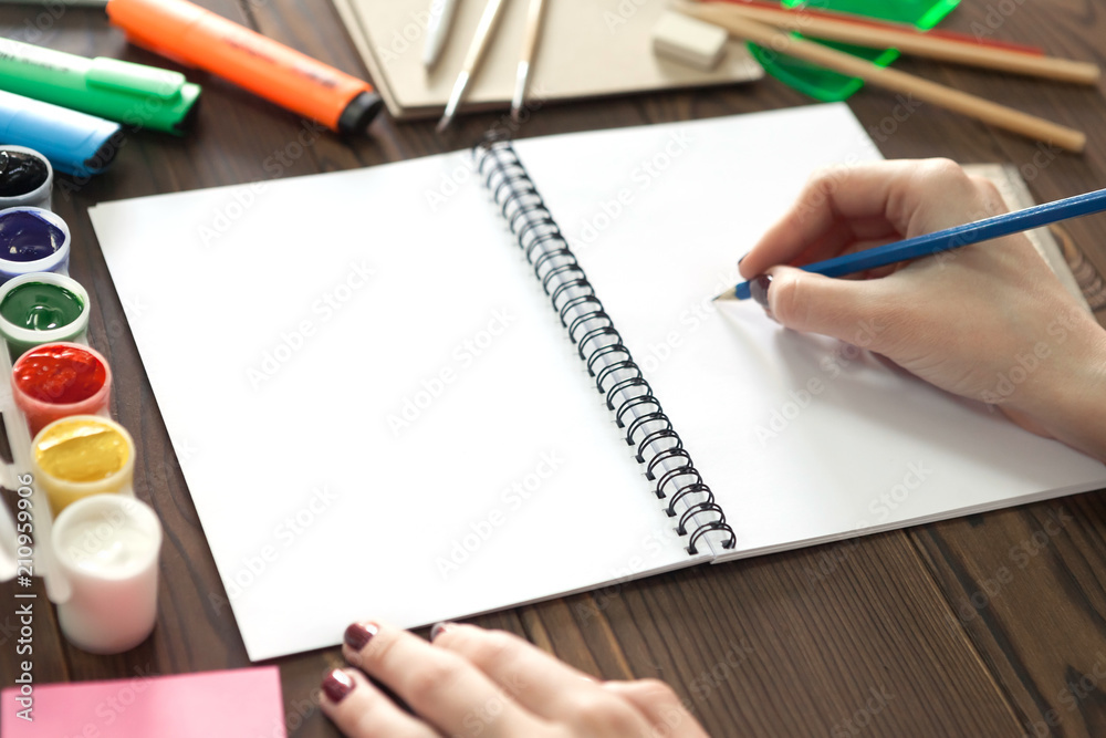 the girl draws a pencil in a notebook the girl draws a pencil in a notebook