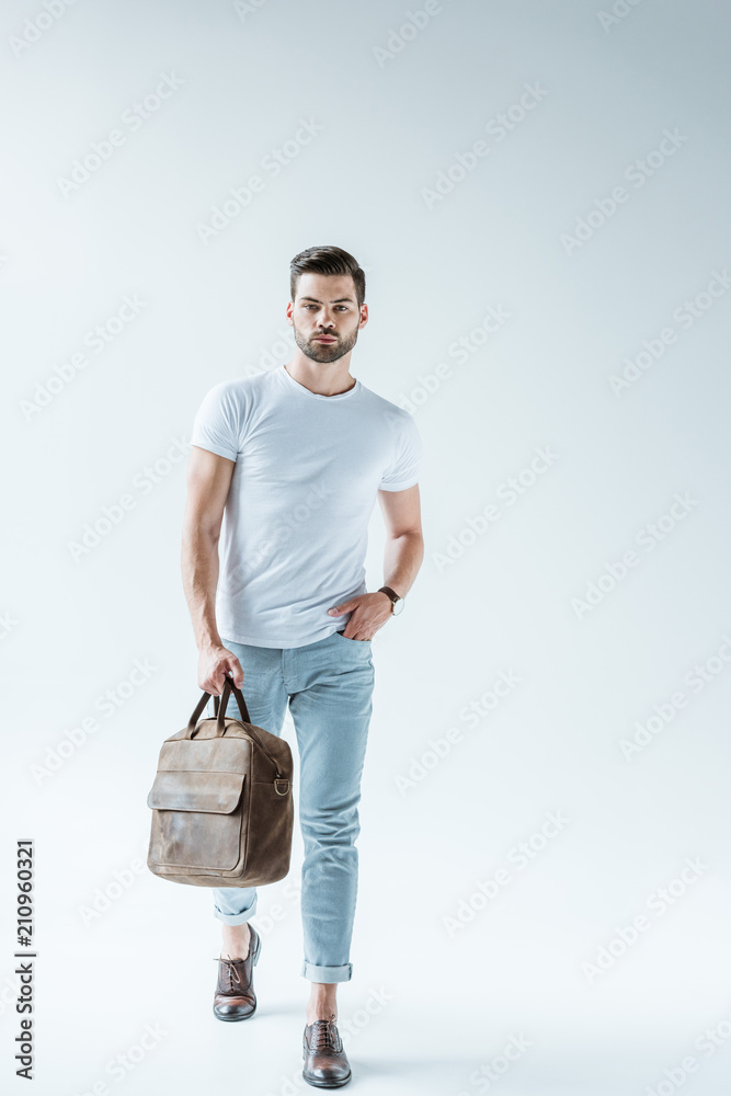 Fashionable confident man carrying briefcase on white background Fashionable confident man carrying briefcase on white background
