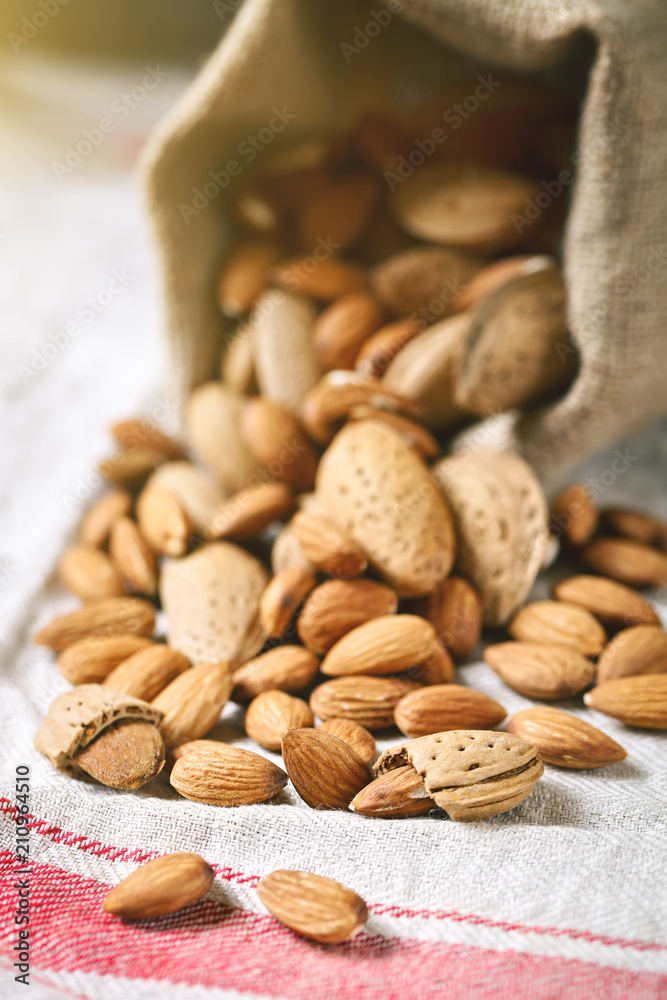 Almond on a wooden table in the summer garden. Useful food. Healthy lifestyle. Almond on a wooden table in the summer garden. Useful food. Healthy lifestyle.