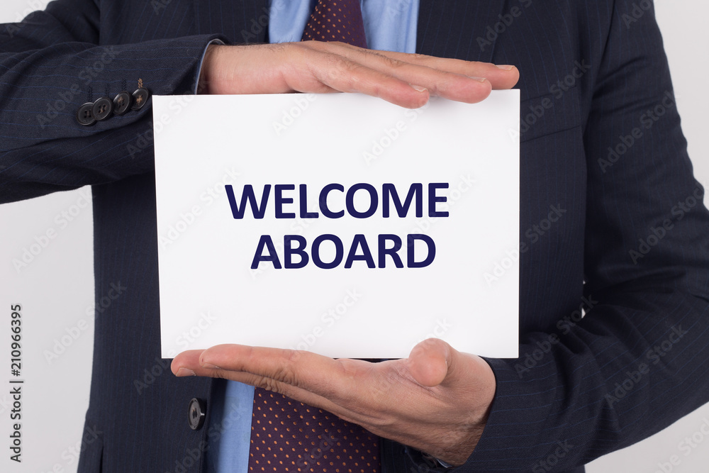 Man showing paper with WELCOME ABOARD text Man showing paper with WELCOME ABOARD text