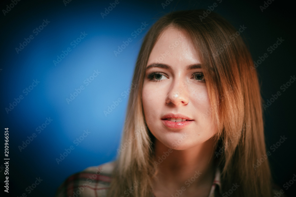 portrait smiling girl on blue background in studio portrait smiling girl on blue background in studio