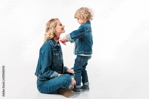 side view of son playing with mothers headband on white