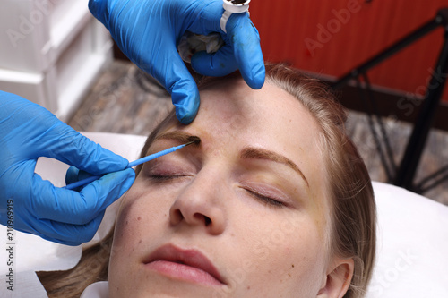 applying Tottoo  Brow Microblading to customer eyebrows