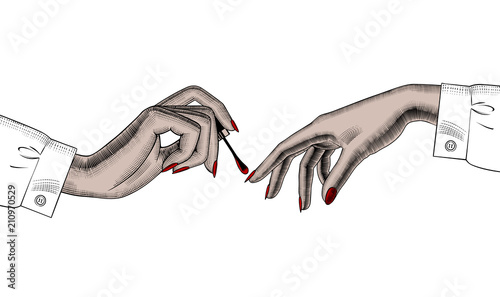 Female hand paints fingernails on the other woman