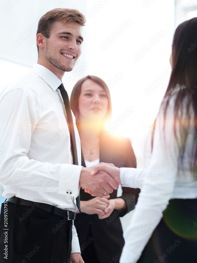 funny smiling businessman shaking hands with his partner. funny smiling businessman shaking hands with his partner.