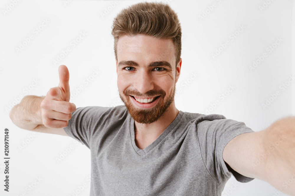 Portrait of a cheerful young bearded man taking a selfie Portrait of a cheerful young bearded man taking a selfie