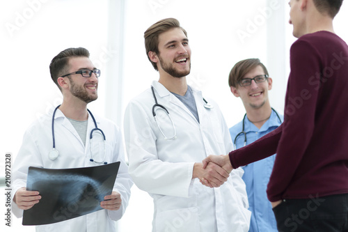 patient shaking hands with doctor.