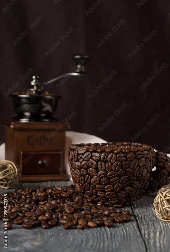 Cup made of coffee beans, scattered grain coffee, isolated on black