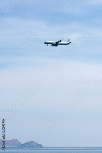 Airplane above sea, prepares to land on the island of Crete
