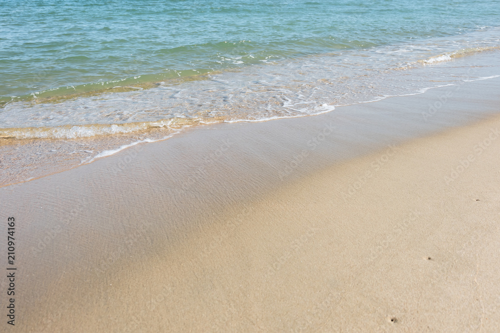 HDR shot of sea shore with wave and white sand during summer day in thailand (selective focus and white balance / color tone shift )