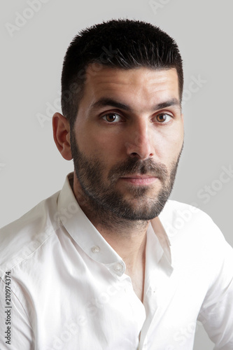Portrait of young attractive bearded man, studio headshot