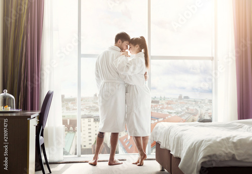 Young couple in love in hotel room in the morning photo