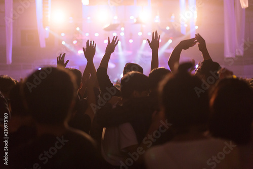 Crowd at concert and blurred stage lights, noise added later in post processing for vintage usage