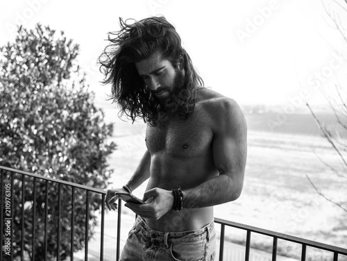 man with long hair with cellphone