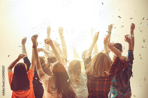Nightlife and disco concept. Young people are dancing in club.