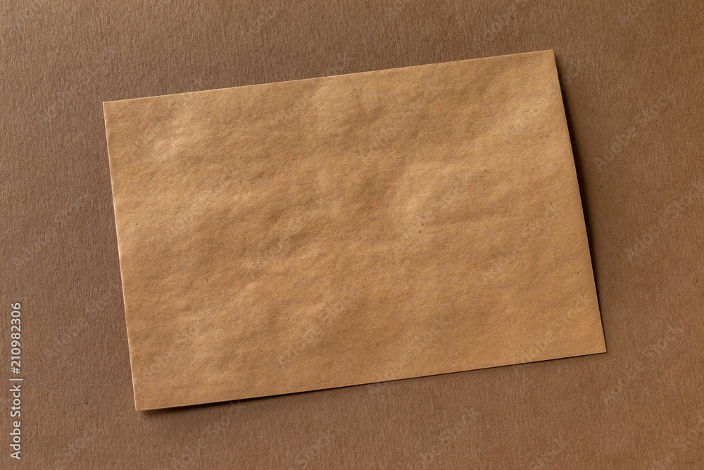 Mockup of craft paper letterhead at brown textured paper background. Mockup of craft paper letterhead at brown textured paper background.
