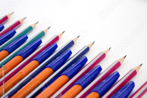 Colored pencils lined up in row