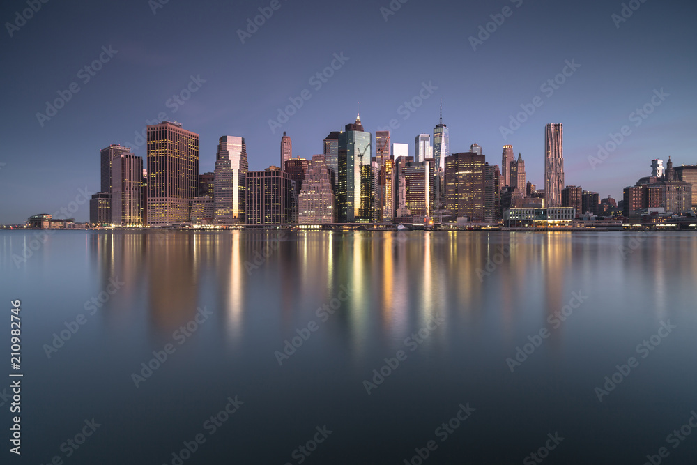 Downtown Manhattan view with water reflection
