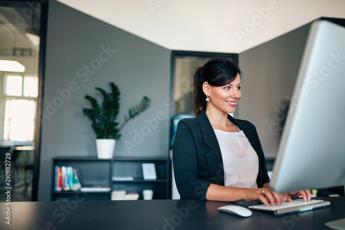 Business lady working on computer in the office.