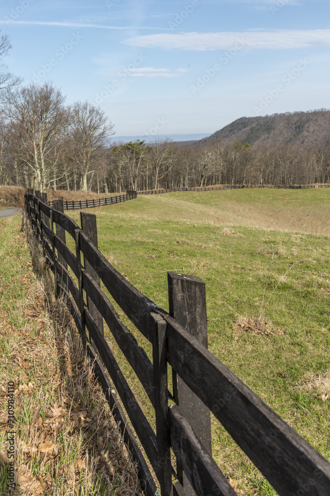 Wooden fence twisting beside the field