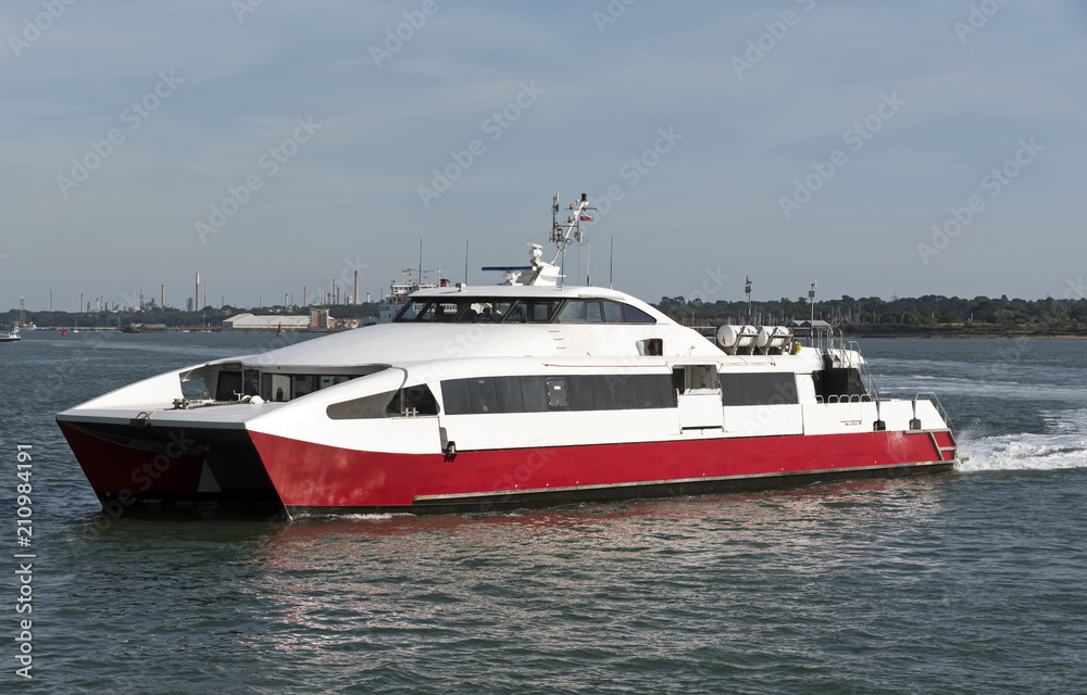 A passeger cataraman ferry underway on a coastal route. A passeger cataraman ferry underway on a coastal route.