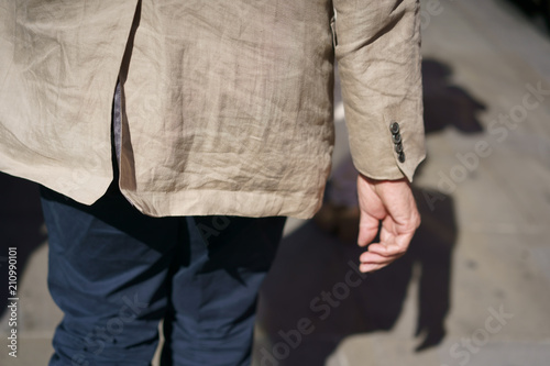 Man in a beige crumpled jacket