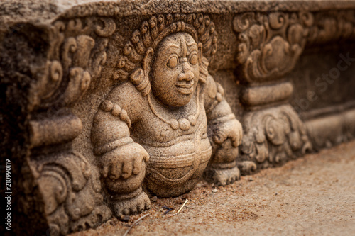 Sri Lanka, Anuradhapura. Mythological character on a stone wall of a buddhist temple close-up photo