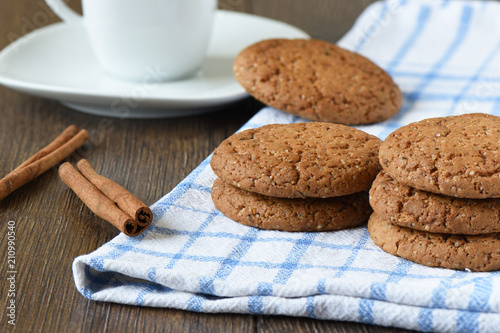 Oatmeal cookies, cinnamon and a cup of coffee. photo