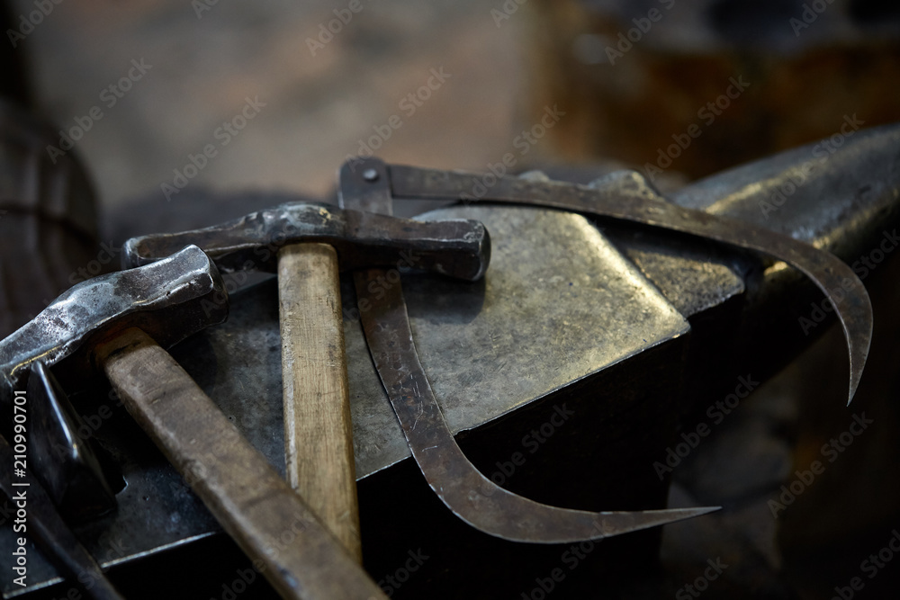 Working metal tools in blacksmith's workshop, close-up, selective focus, nobody Working metal tools in blacksmith's workshop, close-up, selective focus, nobody