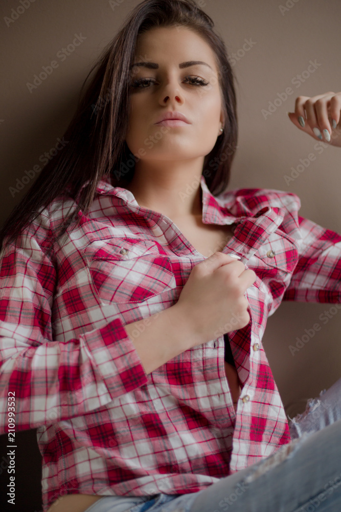 Young brunette woman with black bra posing with open shirt Young brunette woman with black bra posing with open shirt
