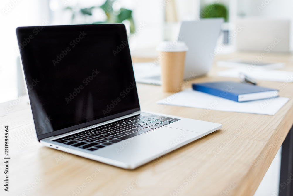 laptop with blank screen on table in business office laptop with blank screen on table in business office