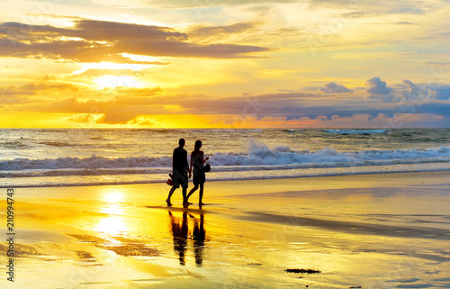 Couple walking tropical  be...