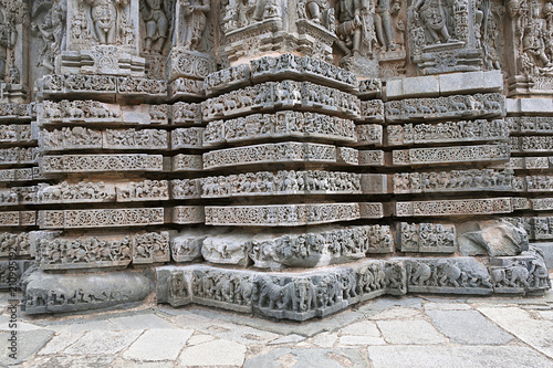 Friezes of animals, scenes from mythological episodes from Ramayana and Mahabharata, at the base of temple, Kedareshwara temple, Halebidu, Karnataka. photo