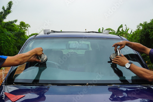 repairing windshield replace windscreen wiper tools fix crack broken front window glass car vehicle services by Glazier. Maintenance repair, replace windshield, windscreen car wiper concept.