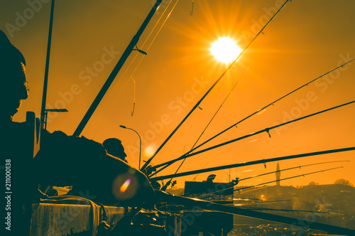 Photography Silhouettes of fishermen fishing on Galata Bridge to relax and enjoy their hobby