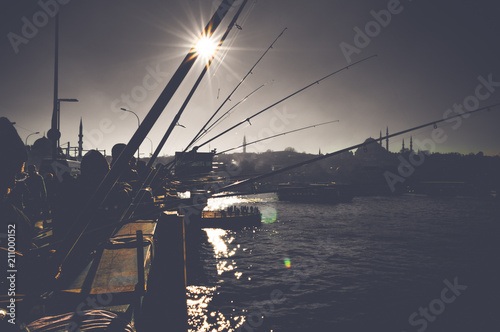 Photography Silhouettes of fishermen fishing on Galata Bridge to relax and enjoy their hobby