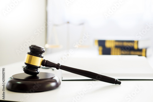 gavel and soundblock of justice law and lawyer working on wooden desk background. photo