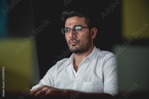 Принти на полотні Asian businessman concentrating on working at night