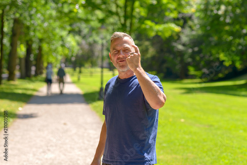 Middle aged man out jogging in a park