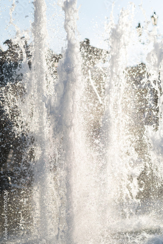 The gush of water of a fountain. Splash of water in the fountain, abstract image.Foam in the sea. The gush of water of a fountain. Splash of water in the fountain, abstract image.