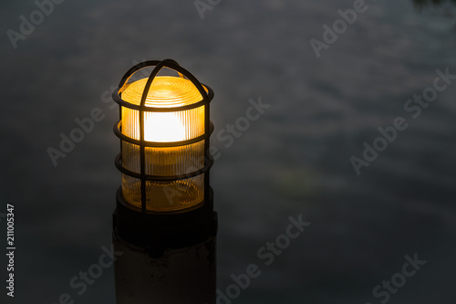 The post lamp with blurred water background