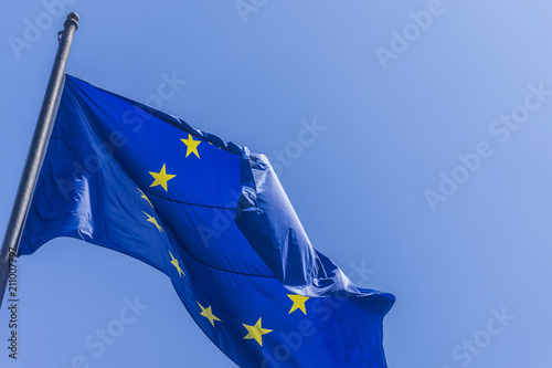European union flag flying against a blue sky background