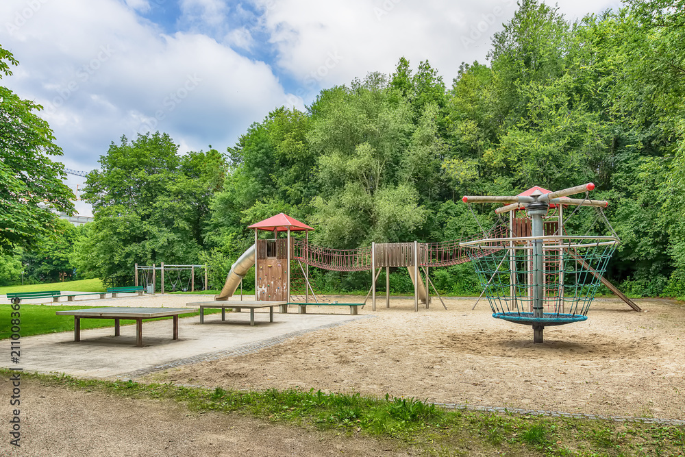 Munich, Germany - June 09, 2018: Colorful playground on yard in the park. Munich, Germany - June 09, 2018: Colorful playground on yard in the park.