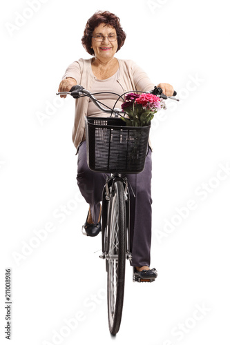 Elderly woman riding a bicycle towards the camera photo