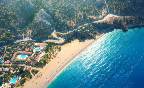 Fototapeta Naklejka Na Ścianę i Meble -  Aerial view of sandy beach in Oludeniz, Turkey. Summer landscape with mountains, sea with azure water, mountain road, buildings, hotels, forest, in bright sunny day. Travel background. Top view.Nature