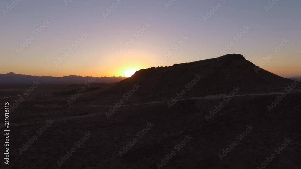 Aerial of the sunset behind a mountain in the desert Aerial of the sunset behind a mountain in the desert