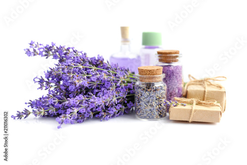 Spa products and lavender flowers on a white background