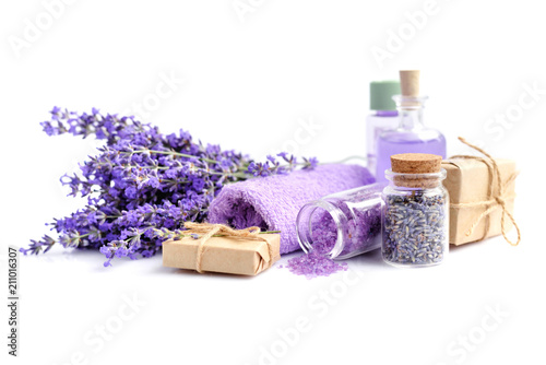 Spa composition with flowers of lavender, salt and bottle of essential oil on white background