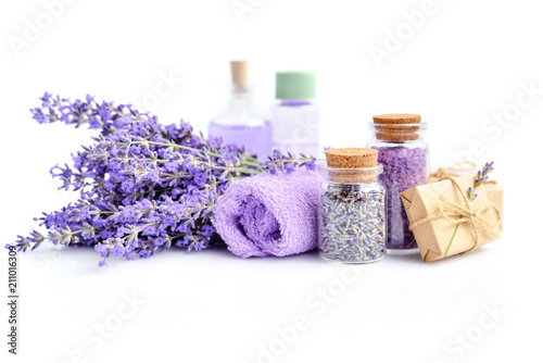 Spa products and lavender flowers on a white background