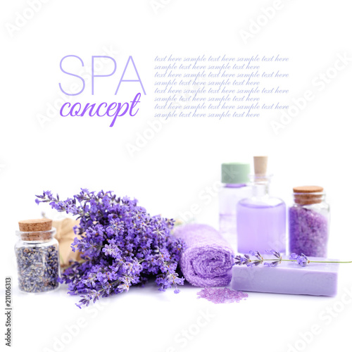 Spa composition with flowers of lavender, soap, salt and bottle of essential oil on white background